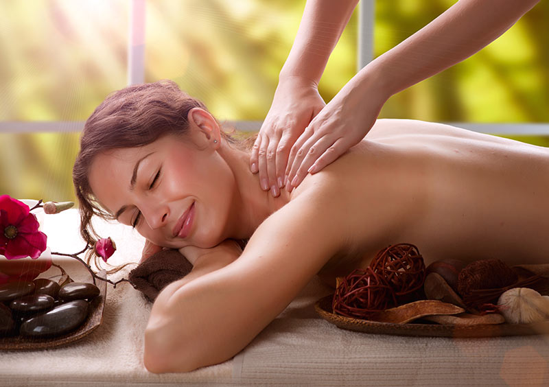 A lady receiving a relaxing neck and shoulder massage